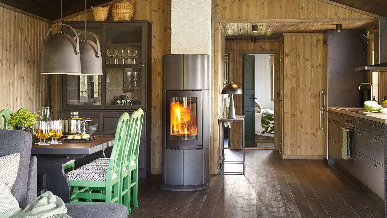 Hytte med mørkt interiør og mørkt furugulv i heltre.