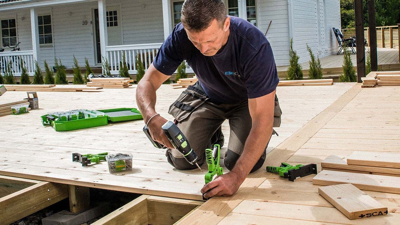 Mann som bygger terrasse.