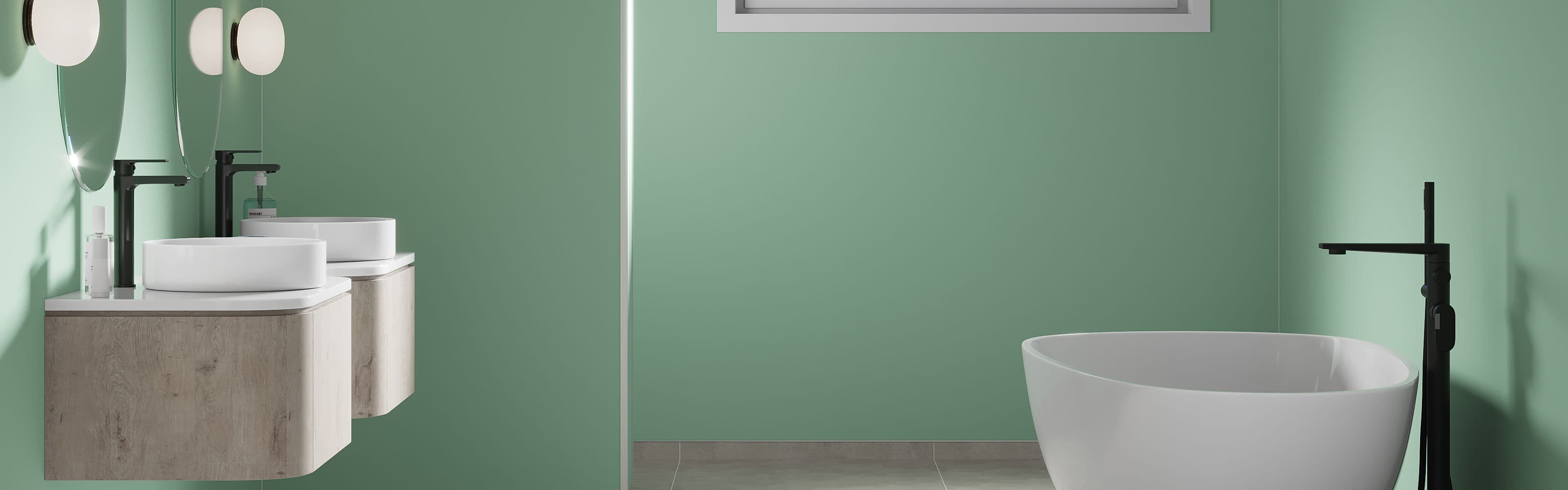 Bad med to servanter, badekar og lysegrønne veggplater.